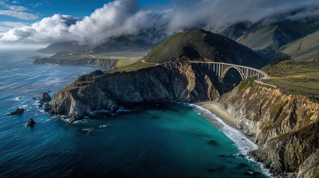 A stunning coastal view featuring a bridge over cliffs, with mountains and clouds in the background, showcasing vibrant blue waters and rugged terrain. - Powered by Adobe
