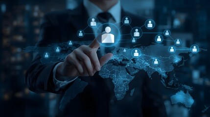 Businessman touching a glowing human icon connected to a global network map representing digital connection, human resource management, and worldwide business strategy