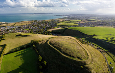 Chalbury early Iron Age hillfort. Single rampart strategic site. Enclosed depressions are hut platforms and storage pits. View S over Weymouth Bay