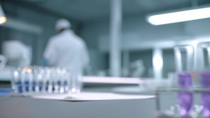 Scientist expertly adding purple liquid to test tubes, driving innovation in a modern lab for cutting edge medical research