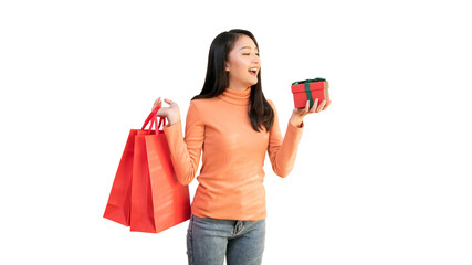 Happy Asian woman holding red shopping bags and gift box for Christmas and New Year holiday shopping.
