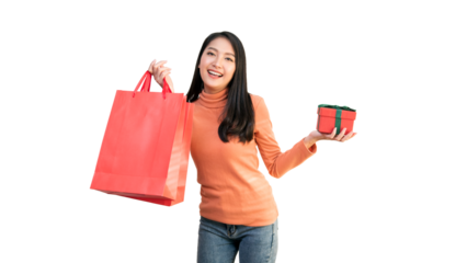 Happy Asian woman holding red shopping bags and gift box for Christmas and New Year holiday shopping.