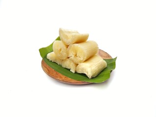 Steamed cassava on a wooden plate isolated on white background. Healthy food lifestyle 