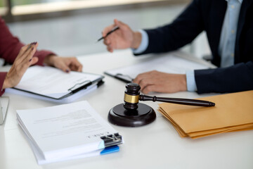 Adult legal professionals client meeting discussing important case documents justice advice at law office court room table for agreement resolution