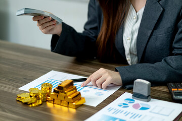Adult Asian businesswoman financial data analysis investment management cash gold asset reports office desk wealth growth strategy
