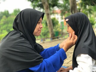 Mother Touching Her Daughter&rsquo;s Cheek in a Sweet, Heartfelt Smile