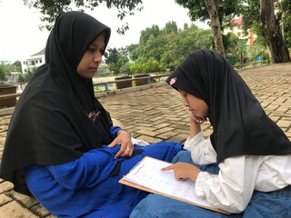 Outdoor Education with Hijab-Wearing Mother and Daughter