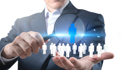 Business person using magnifying glass to select a standout figure from a crowd