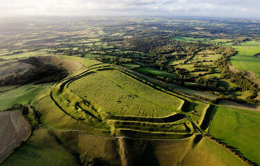 Eggardon Hill multivallate Iron Age hillfort, Dorset. Visible hut site depressions and Bronze Age linear earthworks and bowl barrow. Octagon is recent