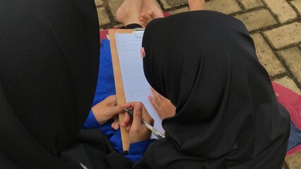 Mother Supporting Daughter’s Study Time in the Park