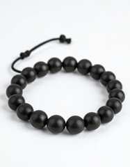 Obraz premium Black Round Beads Bracelet with Adjustable Cord on Clean White Background