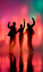Fototapeta premium A motivated team silhouetted against a bold sunset, raising arms as a symbol of ambition.