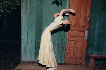 woman yellow dress backbend door portrait outdoor pose authenticity inclusivity