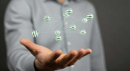 A man in a gray shirt holds green striped spheres in a network formation, embodying technology and futuristic concepts for digital connectivity. The design is modern and abstract.