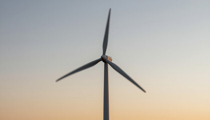 Fototapeta premium Wind turbine blades motion blur against a sunset sky, clean energy motion