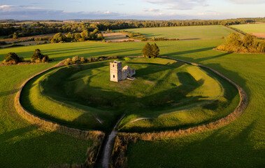 Church Henge. Part of Knowlton Rings Neolithic and Bronze Age earthworks, Dorset. 12th C Knowlton Church central. Great Barrow at 2 o&rsquo;clock. View to NE