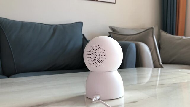 Close up of small camera in modern living room. Smart home security system concept
