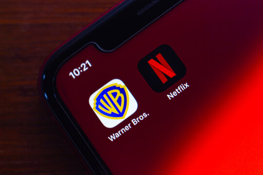 Quito, ECUADOR - Dec 9 2025 : Close-up of Warner Bros and Netflix icons on iPhone, highlighting the ongoing merger news, streaming competition and shifting dynamics in the entertainment industry.