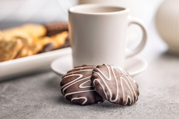 Sweet chocolate cookie and coffee on kitchen table.
