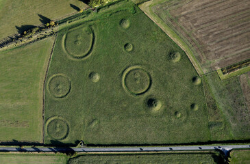 Oakley Down Barrow Cemetery, Dorset. Bronze Age mounds, disc and bowl barrow inhumation and cremation burials.  Ackling Dyke Roman Road at top left
