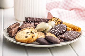 Christmas sweet and cookies on plate on white table.