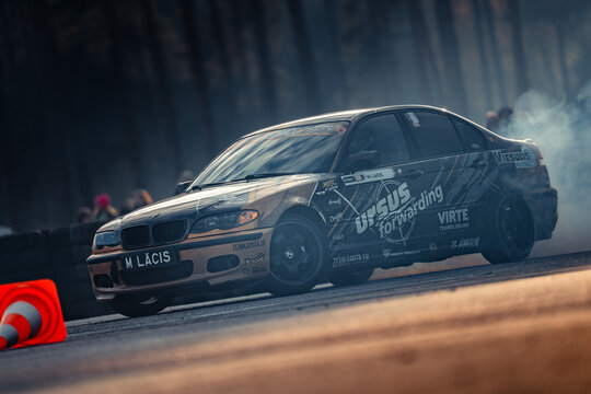 Latvia, Riga 03-05.10.2025. FIA Drifting cup A high-performance car drifting on a track with smoke trailing behind it during a dynamic event
