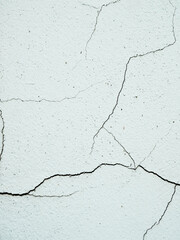 A close-up view of cracks on a concrete wall, revealing texture and detail