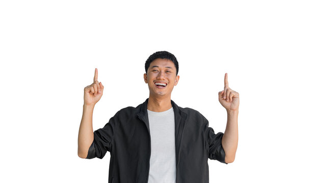 A young Asian man wearing a black coat happy smiling pointing thumbs up isolated on a white background. A man who looks happy to get first place