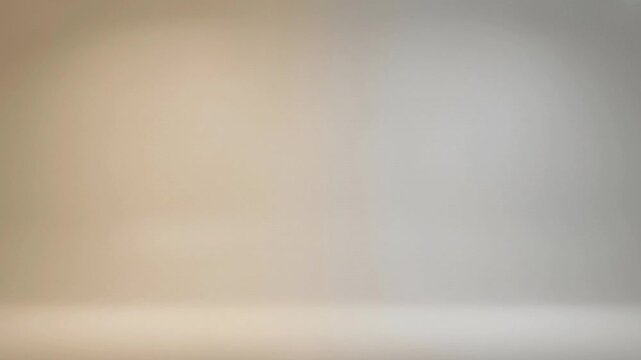 This serene abstract background features a smooth, subtle gradient transitioning gracefully from warm, inviting beige tones to cool, sophisticated grey hues. The gentle shift in color creates a calm a