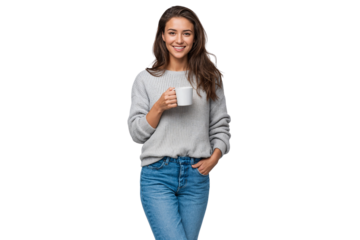 Smiling young woman in a grey knitted sweater and blue jeans, holding a white mug and drinking coffee, isolated on transparent background