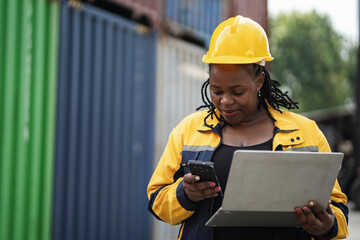 Portrait African woman logistics workers use notebook computer checking container	
