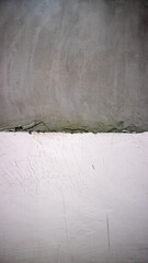 Textured wall with gray and white sections
