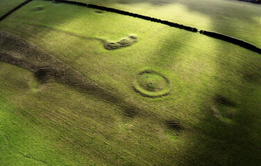 Part of Winterbourne Poor Lot Barrow Cemetery near Winterbourne Abbas, Dorset. Bronze Age burial mound group to north of A35 road. View to east