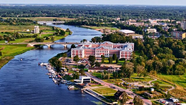 Aerial view of Jelgava Castle with green landscape and Lielupe river on summer day