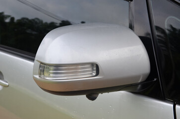 Fototapeta premium Modern Automotive Details: Silver Side Mirror with Camera and Sleek Taillight