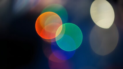 Abstract colorful bokeh light circles glowing against a deep backdrop