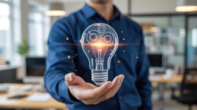 Professional holding glowing conceptual light bulb with internal machinery above open palm