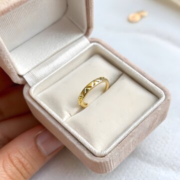 gold toe ring in tiny jewelry box on padded cushion, clean macro product shot
