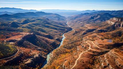 Breathtaking view of winding river surrounded by lush mountains in a tranquil valley during daytime