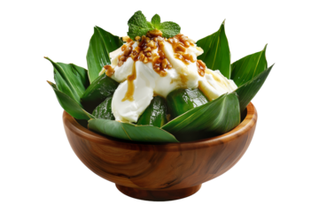 Banana pudding dessert with whipped cream in wooden bowl with green leaves, isolated on white background, concept of sweet treat