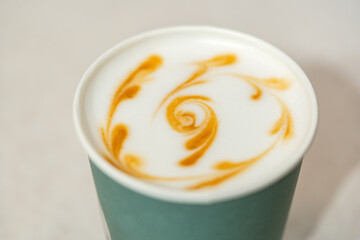 Coffee cup with artistic latte art design in a cozy cafe setting