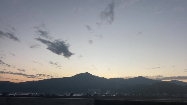 Sunset sky scenery filmed from a moving car in Korea &ndash; warm evening clouds and peaceful roadside landscape
