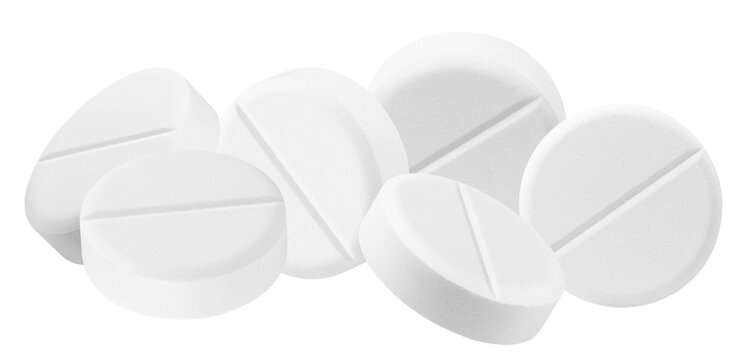 stack of numerous white round medical pills with a clear scored line, forming a pile for pharmaceutical concepts.