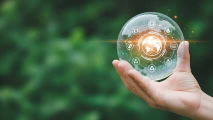 A hand gently holds a transparent globe with interconnected icons representing global sustainability and environmental responsibility against a blurred green natural background