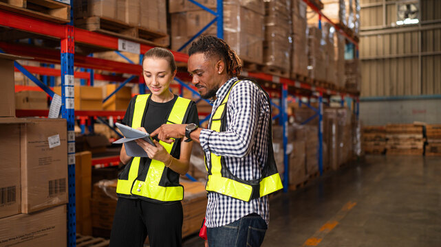 Warehouse manager talking and using digital tablet while checking product in warehouse, Logistic industry concept.