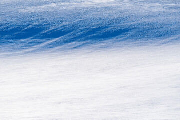 Shadows appearing on the winter snow surface