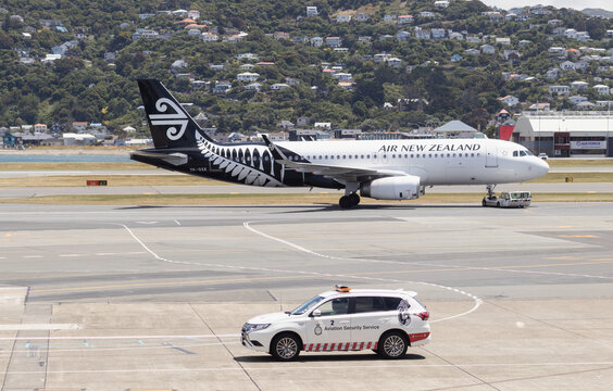 Air New Zealand plane and an Aviation Security Service vehicle on the tarmac at Wellington International Airport. Image taken December 24th, 2024.