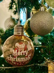 A Christmas tree is adorned with spherical ornaments.
