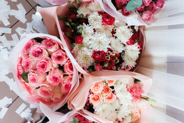 Beautiful floral arrangements of roses and chrysanthemums in soft pastel colors for a special occasion displayed on a table