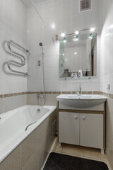 Compact Bright Bathroom Interior with Bathtub and Sink Cabinet